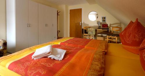 a large bed with two white towels sitting on it at Ferienwohnung Heike Greiner in Bischofsgrün