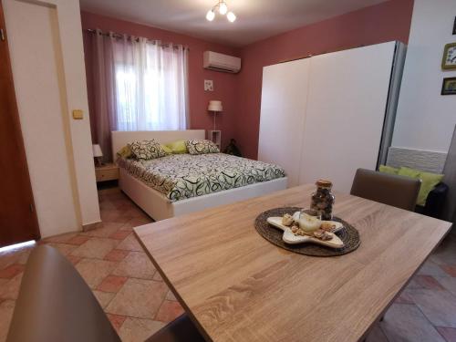 a room with a dining table and a bed at Apartments Emili in Dajla