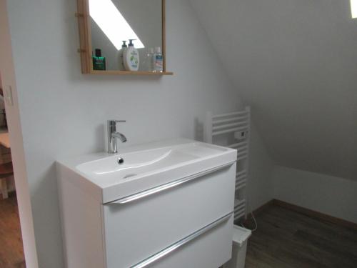 a white bathroom with a sink and a mirror at 6 Grenouill&egrave;re in La Madelaine-sous-Montreuil