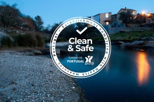 a sign that says clean and safe next to a river at Casa Do Guarda Rios in Ponte Nova