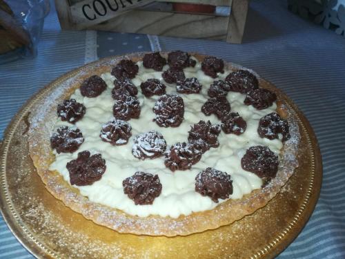 a pizza sitting on a plate on a table at Antico Casale Il Sambuco in Manduria