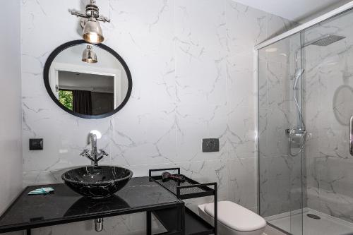 a bathroom with a sink and a mirror at ICON APARTMENTS in Gdańsk
