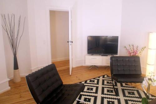 a living room with a couch and a television at Next to New Harbor / 3 BR & 2 Bath Rooms in Copenhagen