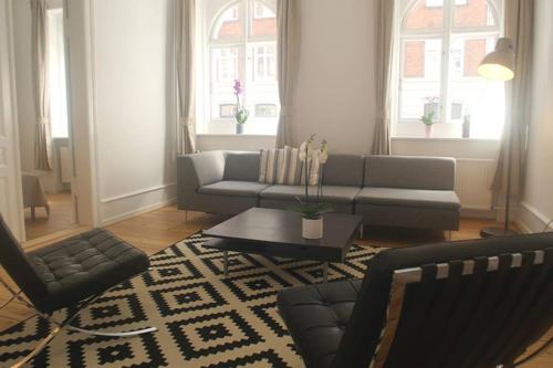 a living room with a couch and a table at Next to New Harbor / 3 BR & 2 Bath Rooms in Copenhagen