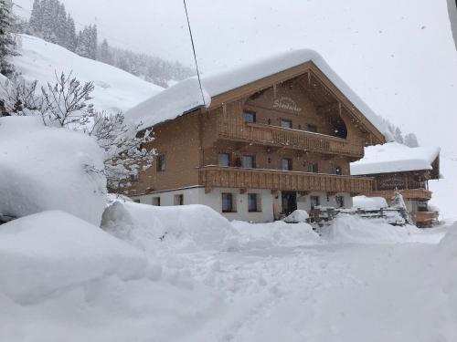 a large building covered in snow in front at Landhaus Staudacher in Gerlos