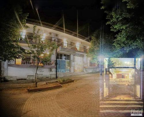 an empty street in front of a building at night at Elizabeth Hotel in Kallithea Halkidikis