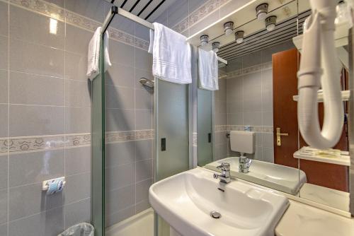 a bathroom with a sink and a shower at Hotel Pian Nava in Premeno