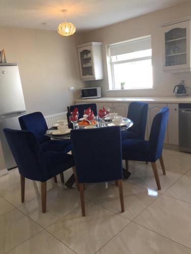 a kitchen and dining room with a table and chairs at St Anthony's Rosslare Strand in Mervyn