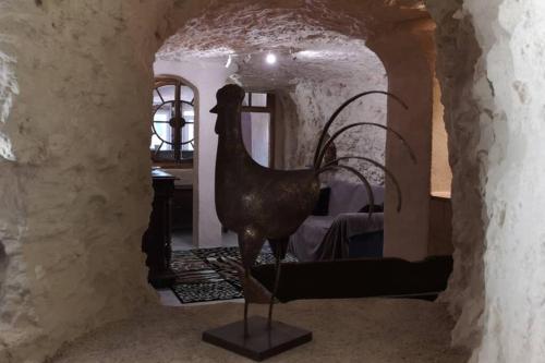 statua di un uccello in una stanza con una camera da letto di Caves du coteau 1 a Lunay