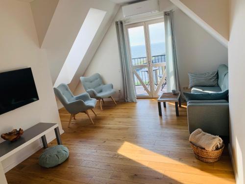 a living room with a view of the ocean at Lagoon Attic Apartment Pervalka in Pervalka