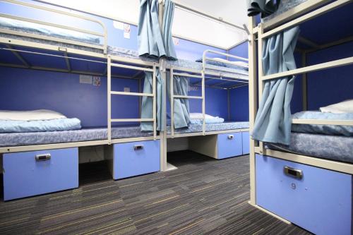a room with three bunk beds on a bus at Smart Hyde Park Inn in London