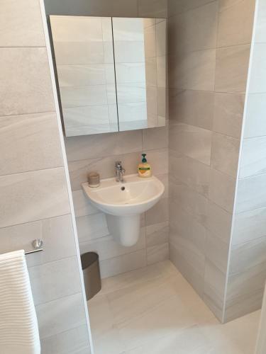 a bathroom with a sink and a mirror at Barr an Uisce in Achill Sound