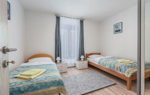 מיטה או מיטות בחדר ב-Apart Residence Blue Sea