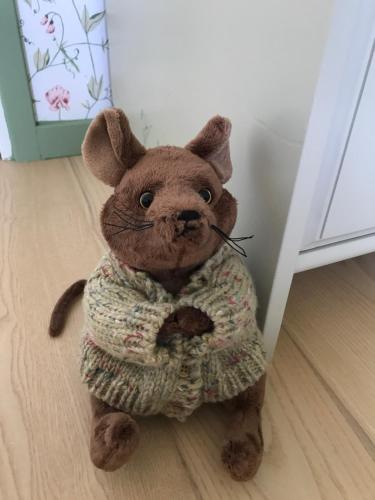a teddy bear wearing a pajamas is sitting on the floor at Anettes Bed & Breakfast Falster in Eskilstrup
