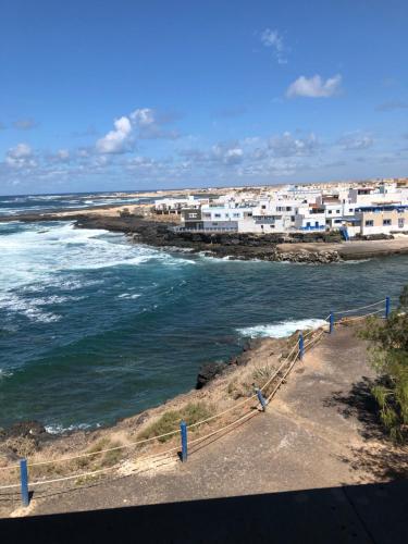 a view of a beach with white buildings and the ocean at Cotillo Ocean View in Cotillo