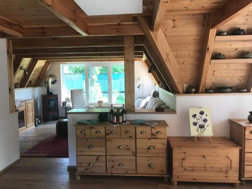 a kitchen with wooden ceilings and a wooden dresser at Matilda I-die außergewöhnliche Finnhütte in Ahrensberg