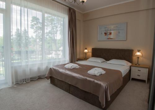 Ένα ή περισσότερα κρεβάτια σε δωμάτιο στο Turaidas Kvartāls