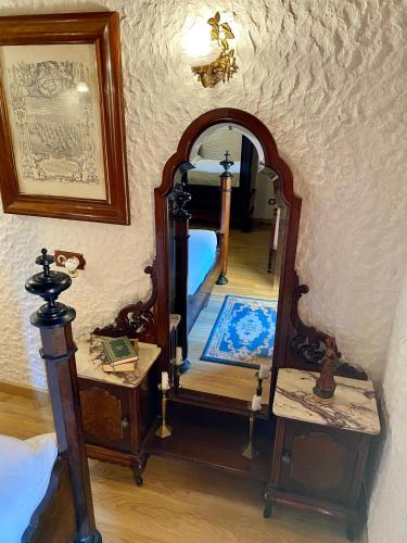 a bedroom with a mirror and a bed in a room at Finca Ses Fontanelles in Andratx