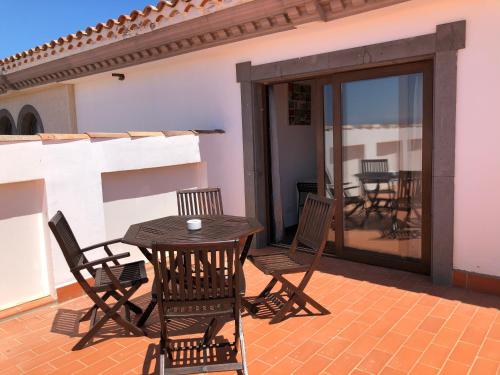 a wooden table and chairs on a patio at Cotillo Ocean View in Cotillo