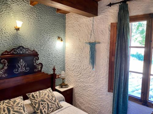 a bedroom with a bed and a window at Finca Ses Fontanelles in Andratx