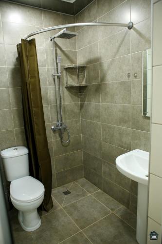 a bathroom with a shower with a toilet and a sink at Guest House in Gyumri in Gyumri
