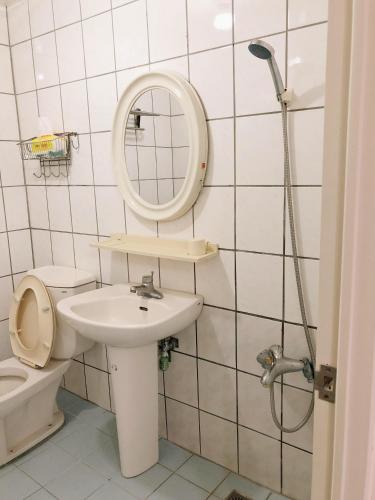 a bathroom with a toilet and a sink and a mirror at Chia Yun Homestay in Luodong