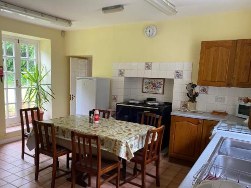 kuchnia ze stołem, krzesłami i lodówką w obiekcie Plas Dolau Country Estate w Aberystwyth