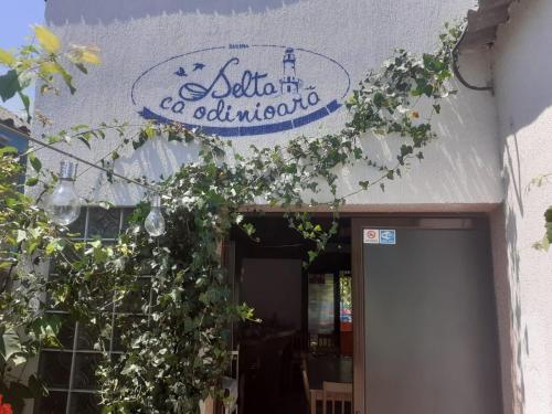 a building with a sign for a restaurant at Delta ca Odinioara in Sulina