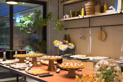 a buffet line with many different types of pies at Hotel Indigo Larnaca - Adults Only, an IHG Hotel in Larnaca