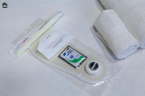 a package of toothbrushes and a roll of toilet paper at Guest House in Gyumri in Gyumri