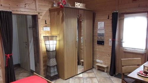 a room with wooden walls and a door with a lamp at Pfalz-Apartment Mein Chalet - Einzigartig in Großkarlbach in Großkarlbach