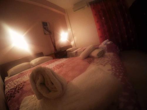 a bedroom with a bed with towels on it at Elizabeth Hotel in Kallithea Halkidikis