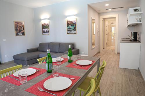 a living room with a table with plates and wine bottles at House & Pool in Mergozzo