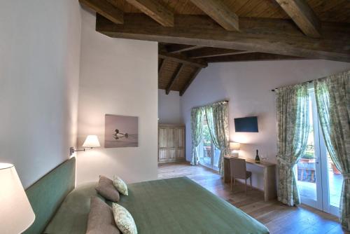 a bedroom with a large green bed in a room at FORESTERIA DEL GAVI in  Tassarolo