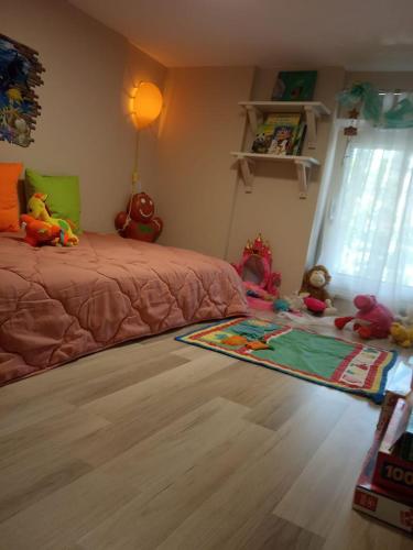 a bedroom with a bed and stuffed animals on the floor at SOTIRIA APARTMENT in Kiáton
