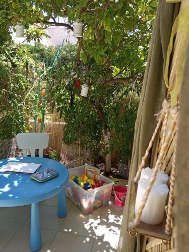 a patio with a blue table and a swing at SOTIRIA APARTMENT in Kiáton