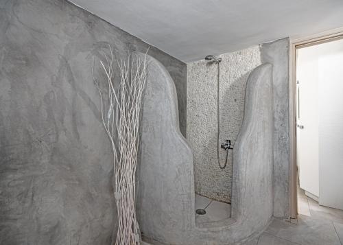 a bathroom with a shower with a shower at CORFOS BLUE MYKONOS in Ornos
