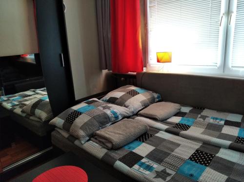 a bedroom with two beds with pillows and a window at Apartament Aurelia in Ustka