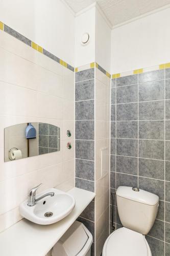 a bathroom with a toilet and a sink at Sea Rooms ENGURE in Engure