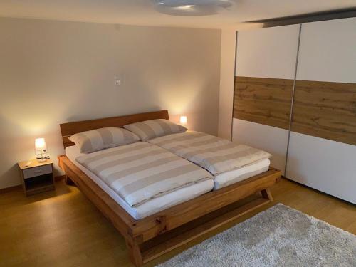 a bedroom with a large bed with two pillows at Haus Raid in Krumbach