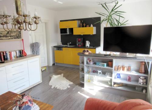 a living room with a flat screen tv on a entertainment center at Urlaubsdomizil Lengefeld in Lengefeld