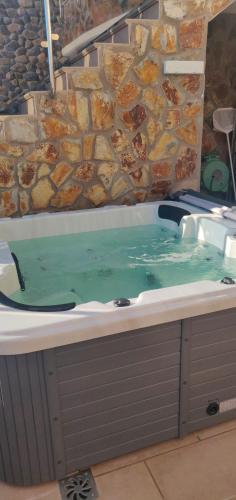 a jacuzzi tub with a bunch of food in it at Casa Holmston, Duplex villa with hot tub in Anfi Tauro Topaz in Mogán