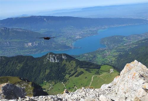 a helicopter flying over a mountain with a lake at Chalet L' ADRET in Bluffy