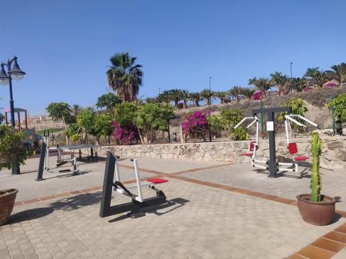 a park with a bunch of playground equipment at Casa Holmston, Duplex villa with hot tub in Anfi Tauro Topaz in Mogán