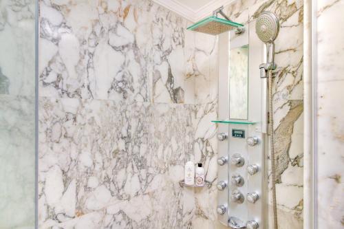 a shower in a bathroom with a marble wall at Casa Holmston, Duplex villa with hot tub in Anfi Tauro Topaz in Mogán