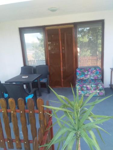 a living room with a chair and a table at Family apartman Ana - Star in Golubac