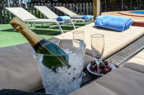 a bottle of champagne in a bucket of ice on a table at Sa Carroca Villa in Sant Josep de Sa Talaia