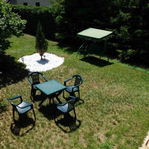 a picnic table and two chairs in a yard at Planinska kuća sa dvorištem in Zlatibor