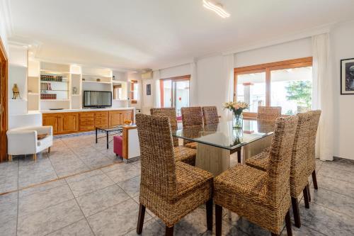 a dining room with a table and chairs at Sa Carroca Villa in Sant Josep de Sa Talaia