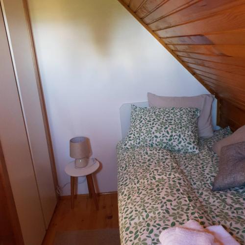 a bedroom with a bed and a small table at Planinska kuća sa dvorištem in Zlatibor